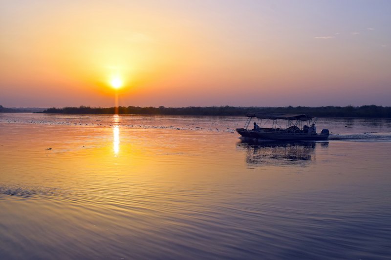 Boat on the water at sunrise
